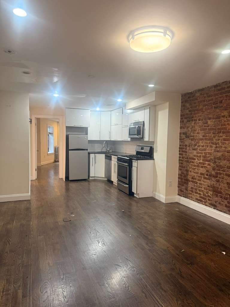 313 Van Buren Street Brooklyn, NY 11221 - Photo 13 of 20 a view of a kitchen with a sink and a refrigerator