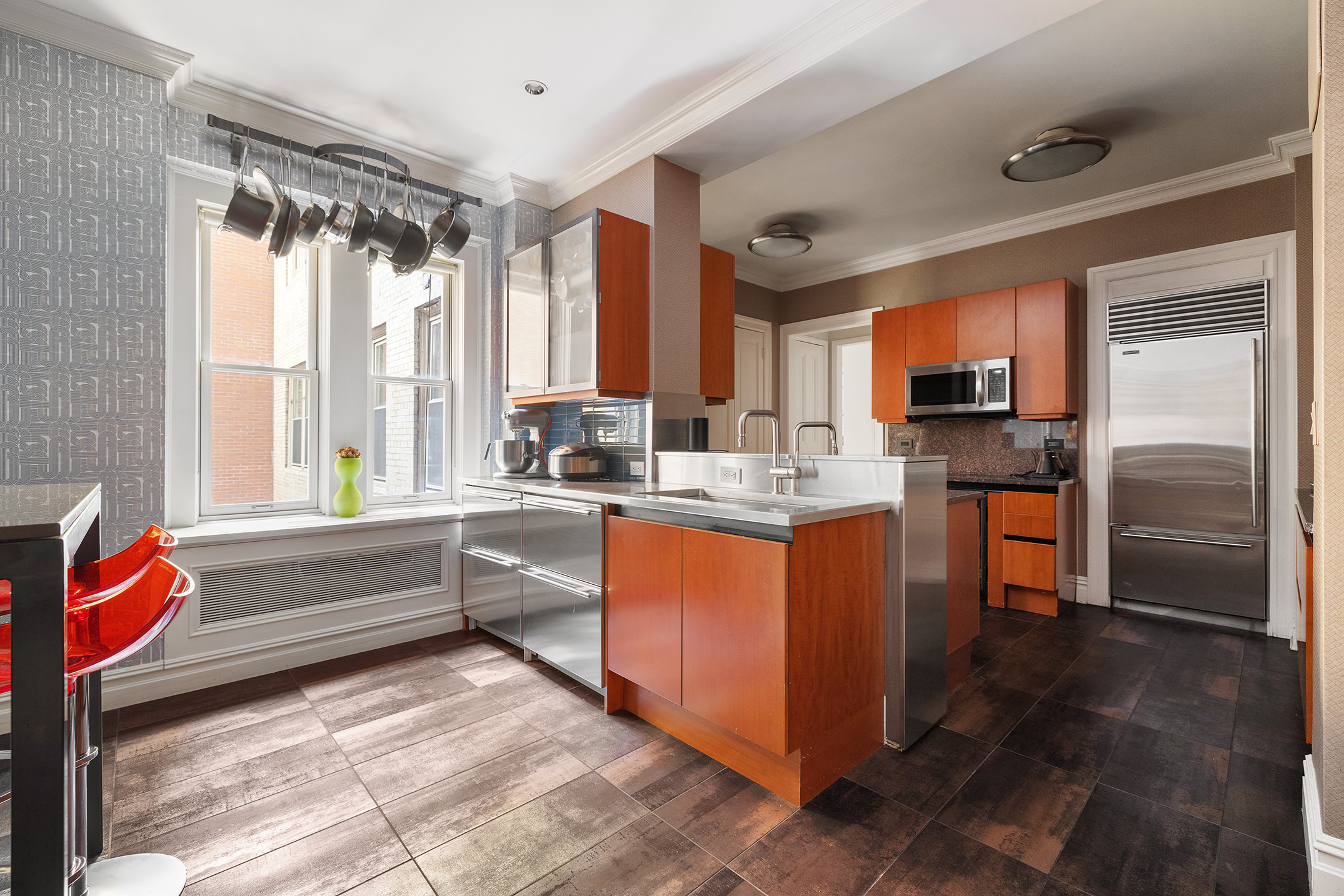 829 Park Avenue, Unit 2/3D Manhattan, NY 10021 - Photo 3 of 18 a kitchen with stainless steel appliances granite countertop a refrigerator and a sink