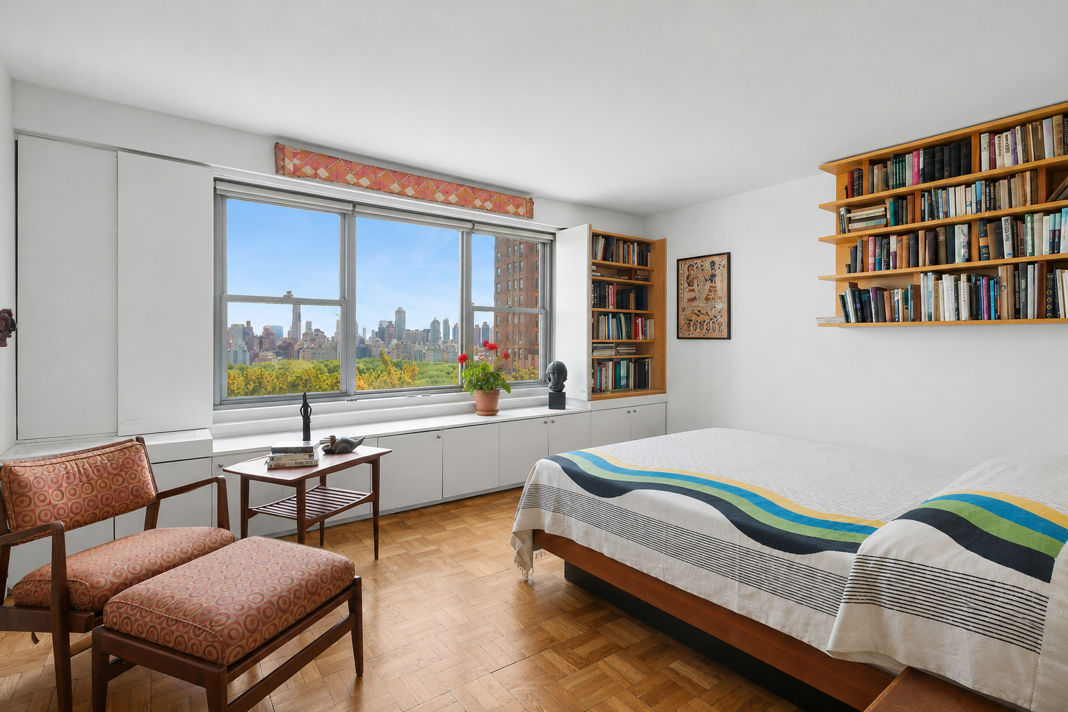 15 West 72nd Street, Unit 25F Manhattan, NY 10023 - Photo 7 of 12 a bedroom with furniture and a book shelf
