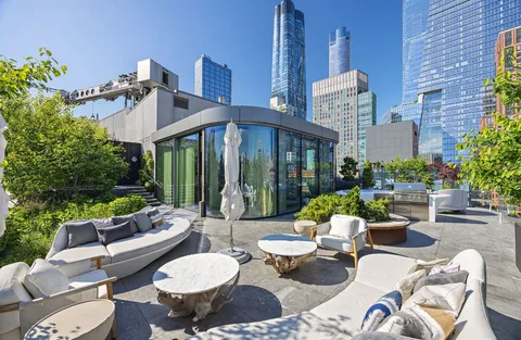 a view of a patio with couches table and chairs and potted plants