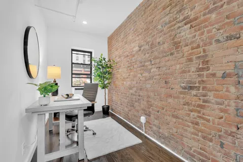 a workspace with furniture and a potted plant