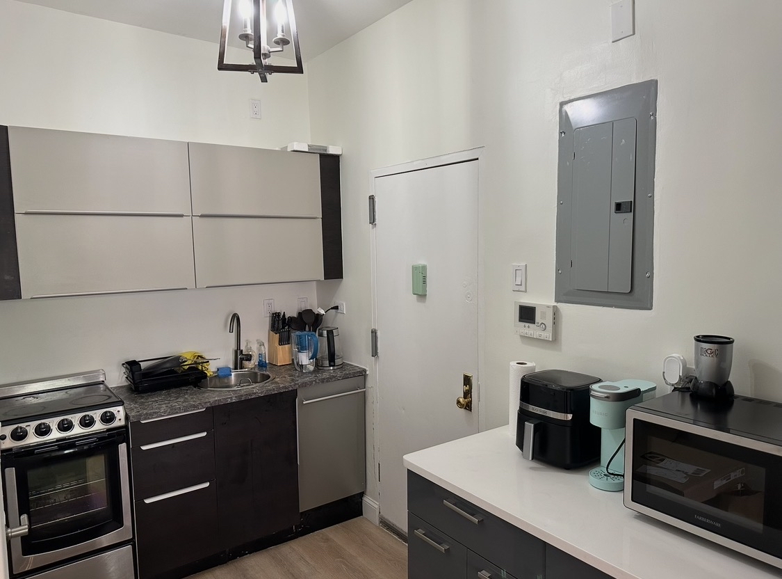 114 East 37th Street, Unit 3A Manhattan, NY 10016 - Photo 8 of 15 a kitchen with a sink stove and microwave