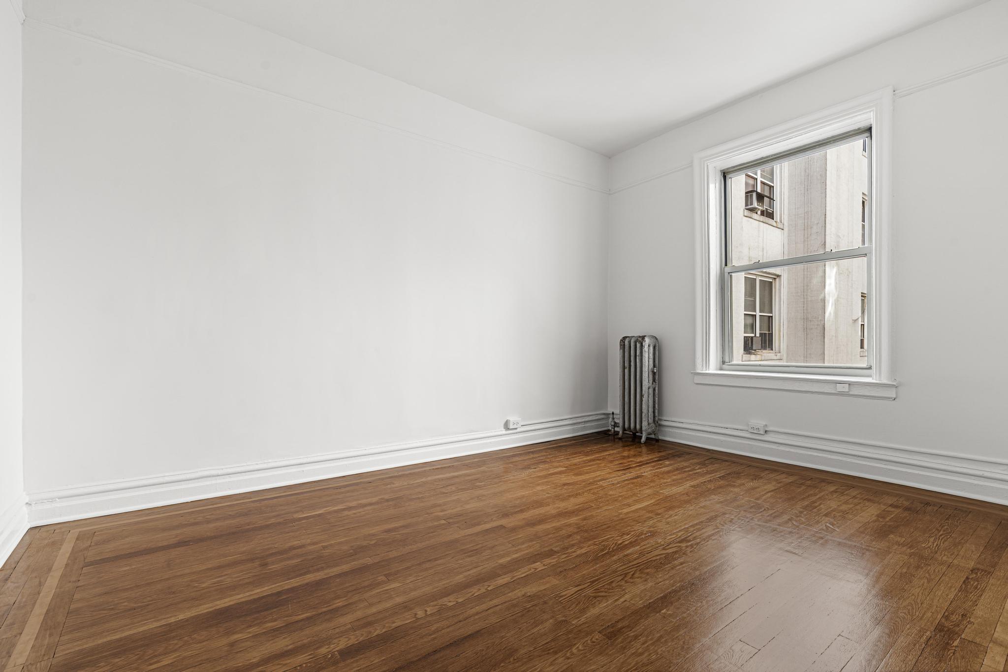 1001 President Street, Unit L2 Brooklyn, NY 11225 - Photo 7 of 19 a view of an empty room with wooden floor and a window