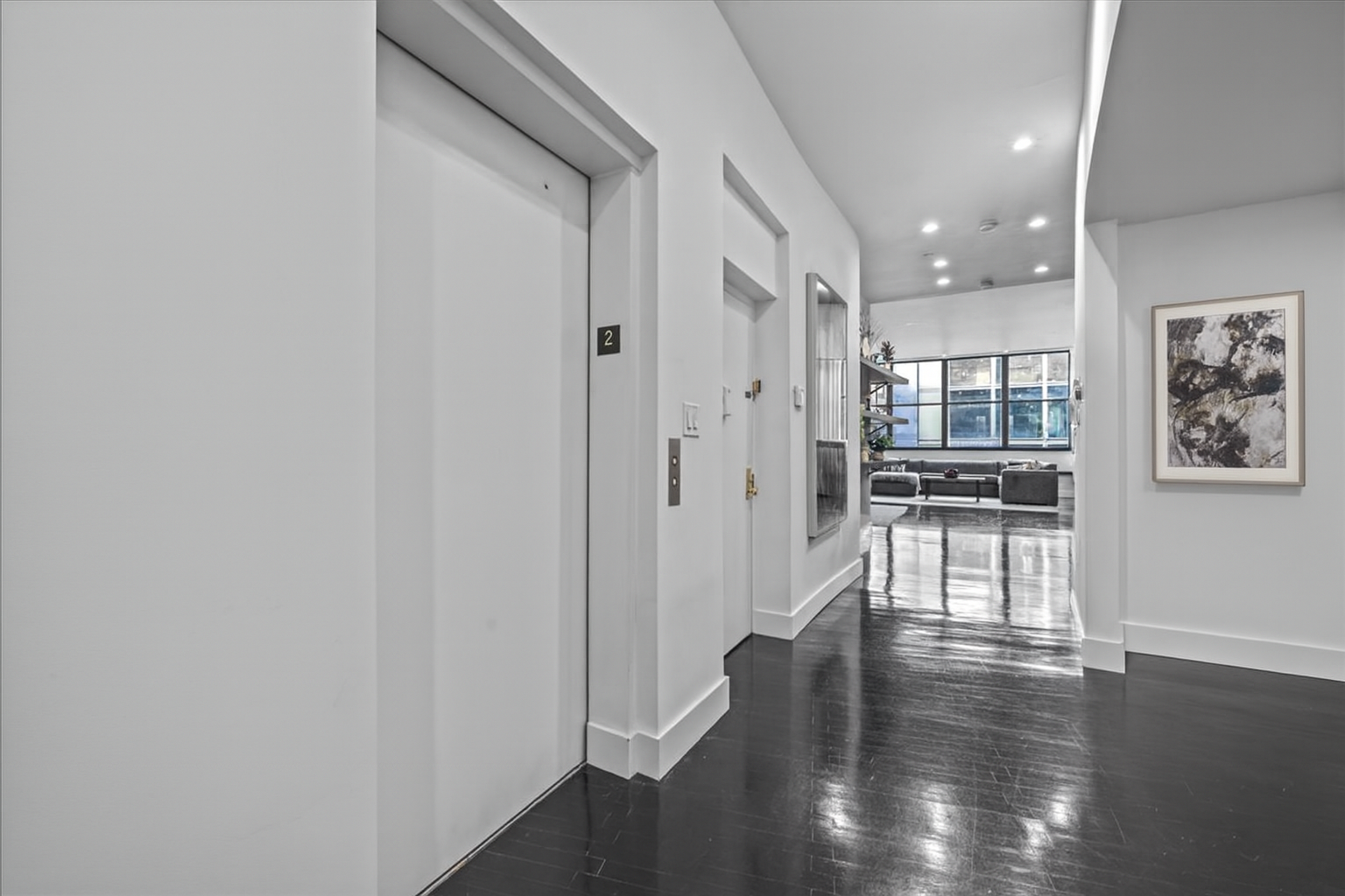 133 West 14th Street, Unit 1 Manhattan, NY 10011 - Photo 7 of 17 a view of a hallway with wooden floor and a cabinet
