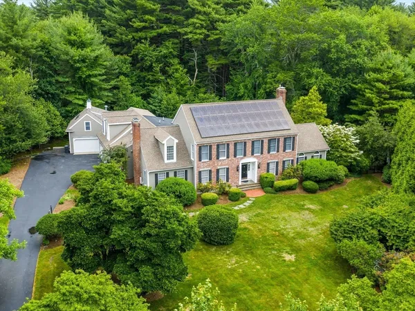 an aerial view of a house with swimming pool and garden