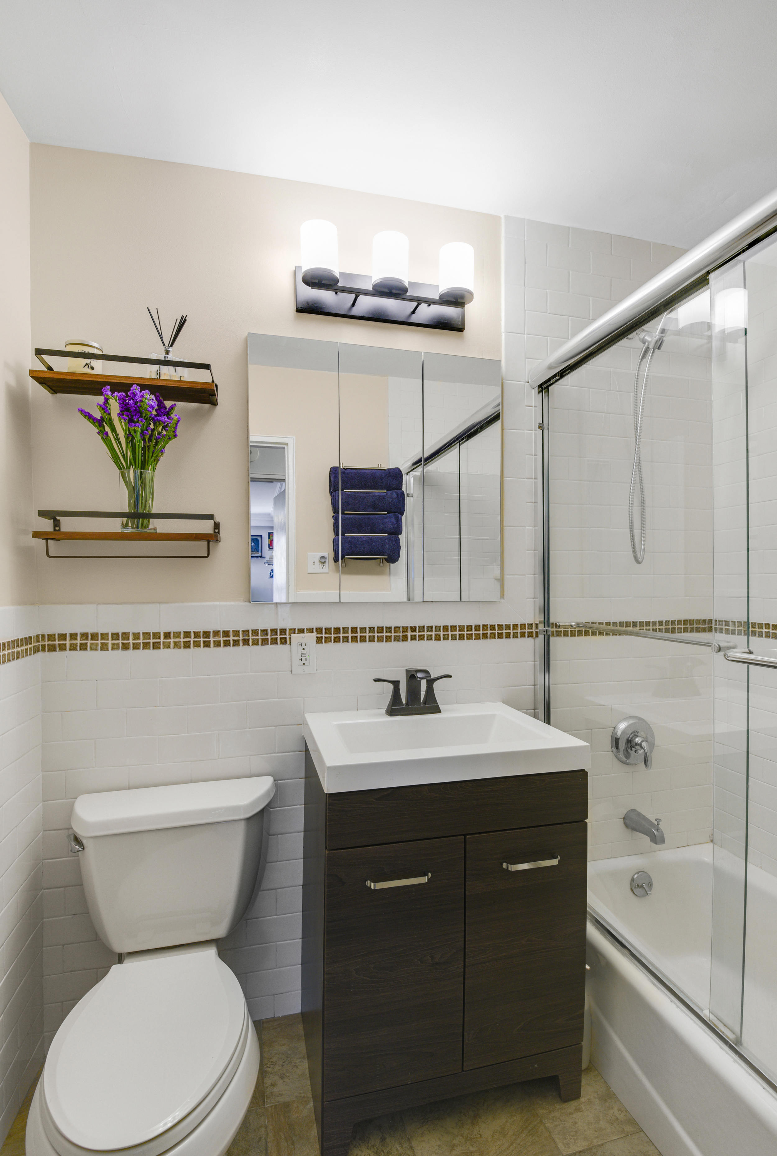 345 East 73rd Street, Unit 7J Manhattan, NY 10021 - Photo 7 of 13 a bathroom with a toilet sink and mirror