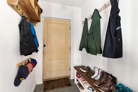 a room with a walk in closet and a rug