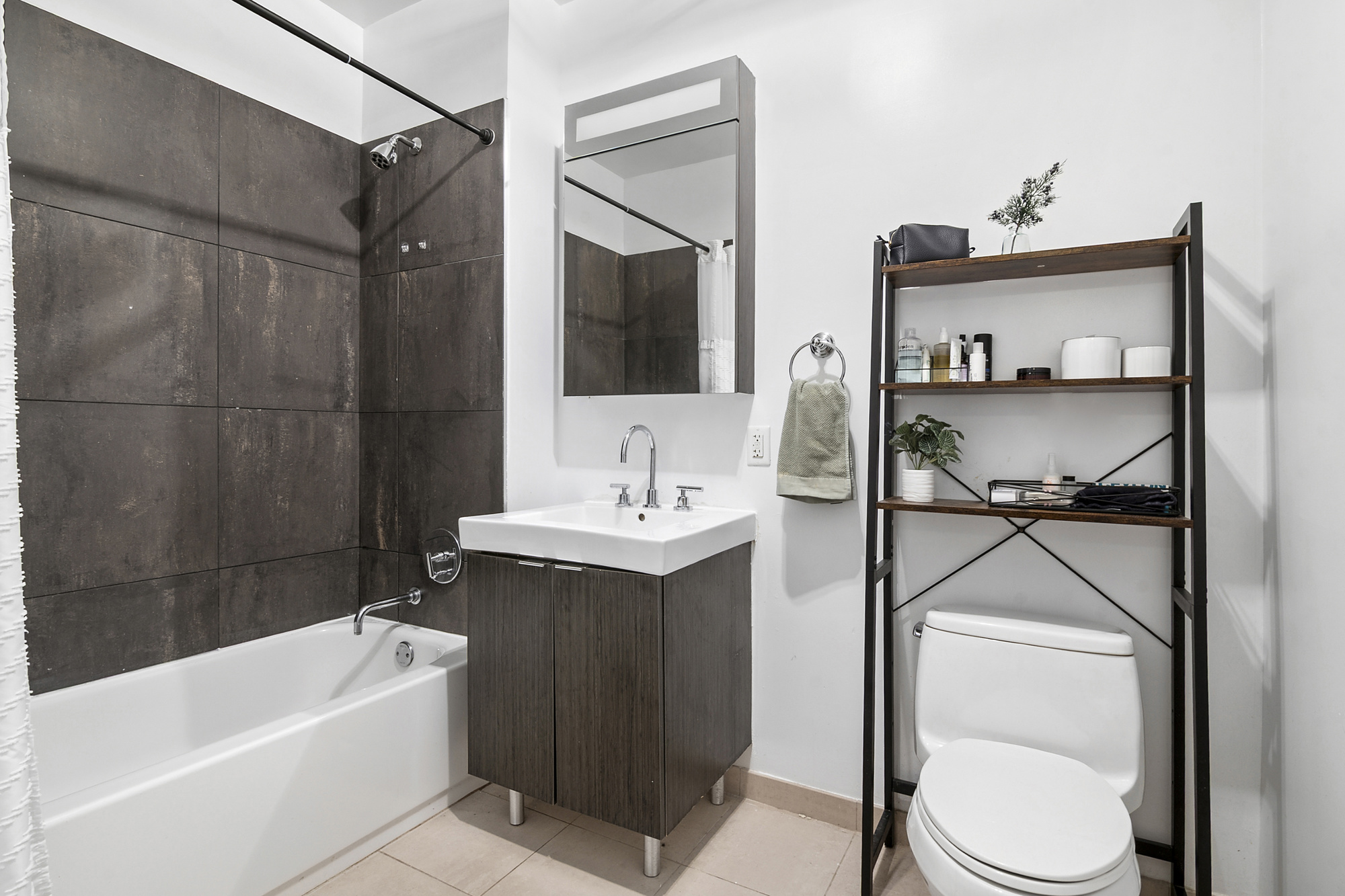 184 Kent Avenue, Unit D101 Brooklyn, NY 11249 - Photo 4 of 8 a bathroom with a sink toilet and shower