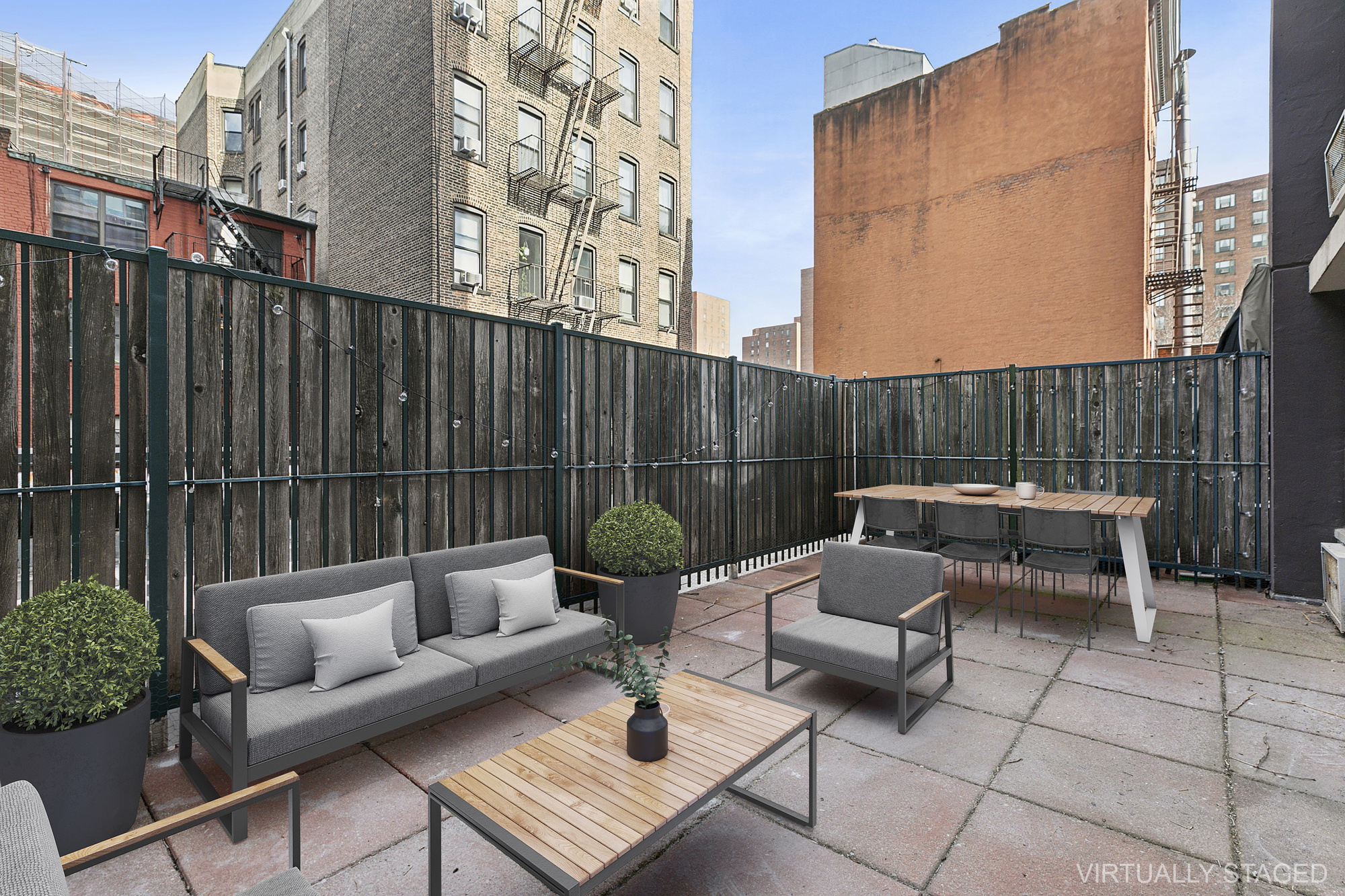 a view of a patio with couches and a table and chairs