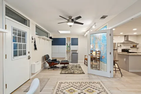 a living room with furniture and wooden floor