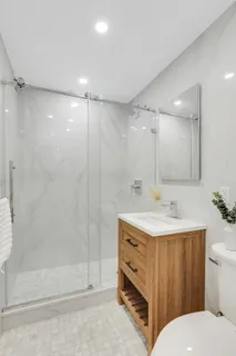 a bathroom with a sink toilet and shower