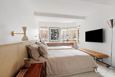 a bedroom with a bed and flat screen tv