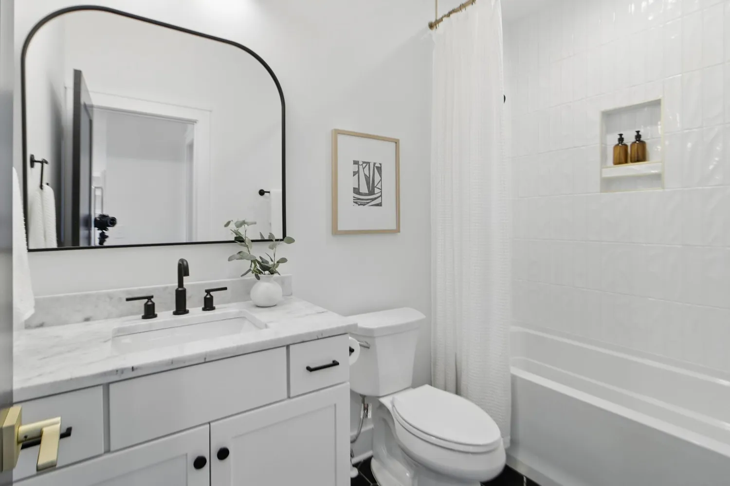 a bathroom with a toilet a sink a mirror and a shower