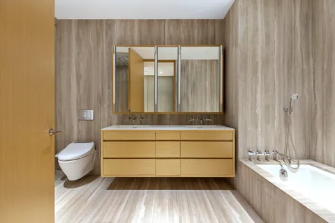 a bathroom with a granite countertop sink mirror vanity and toilet