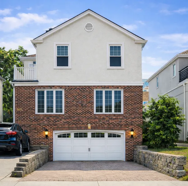 a front view of a house with garage