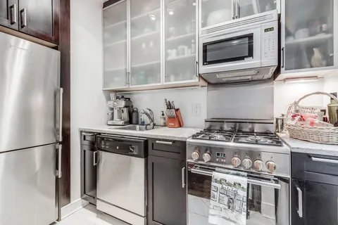 a kitchen with stainless steel appliances granite countertop a stove and a refrigerator
