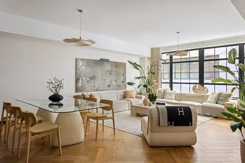 a bedroom with a large bed and a large window