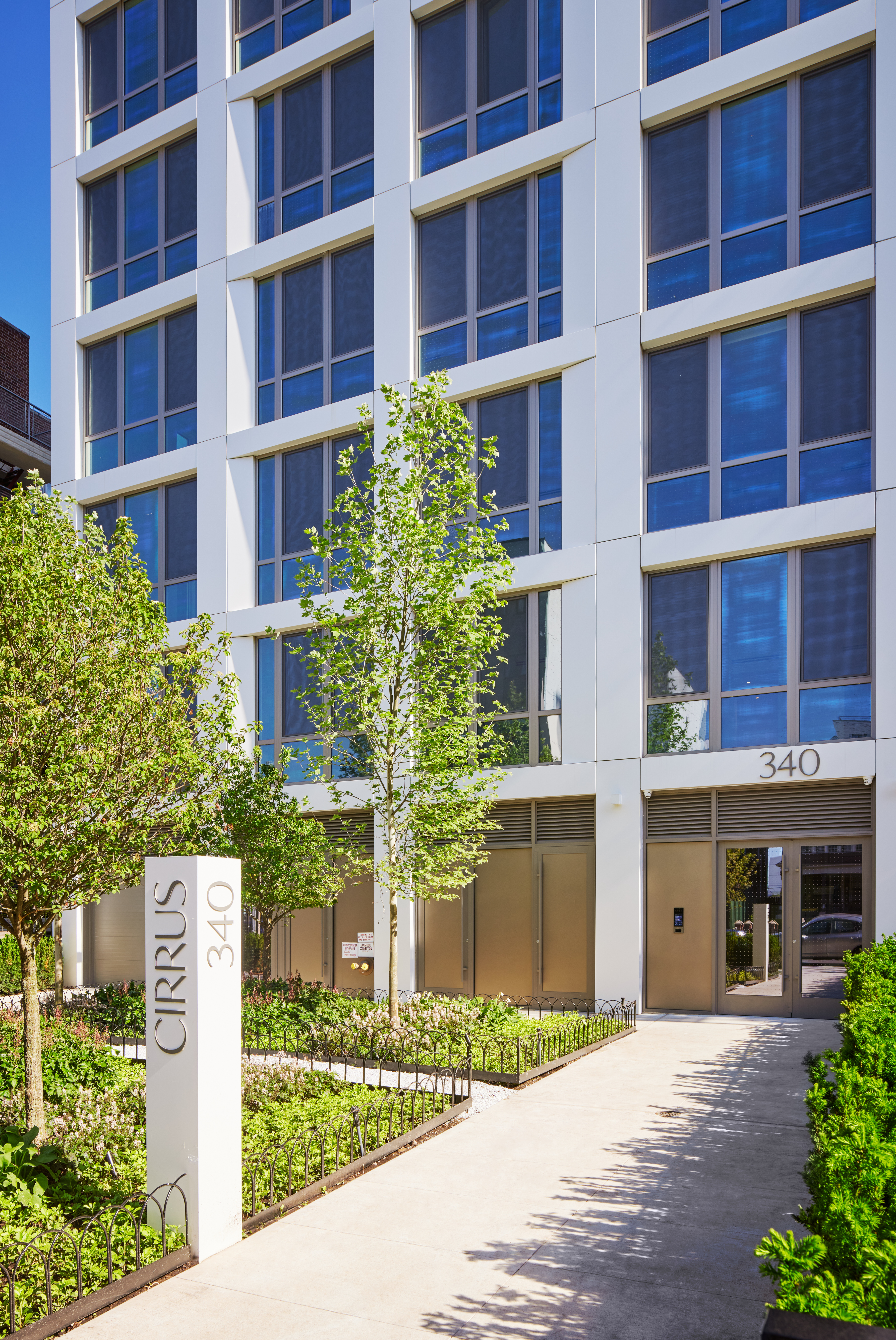340 Lenox Road, Unit 4E Brooklyn, NY 11226 - Photo 23 of 25 a front view of a multi story building with a yard and potted plants