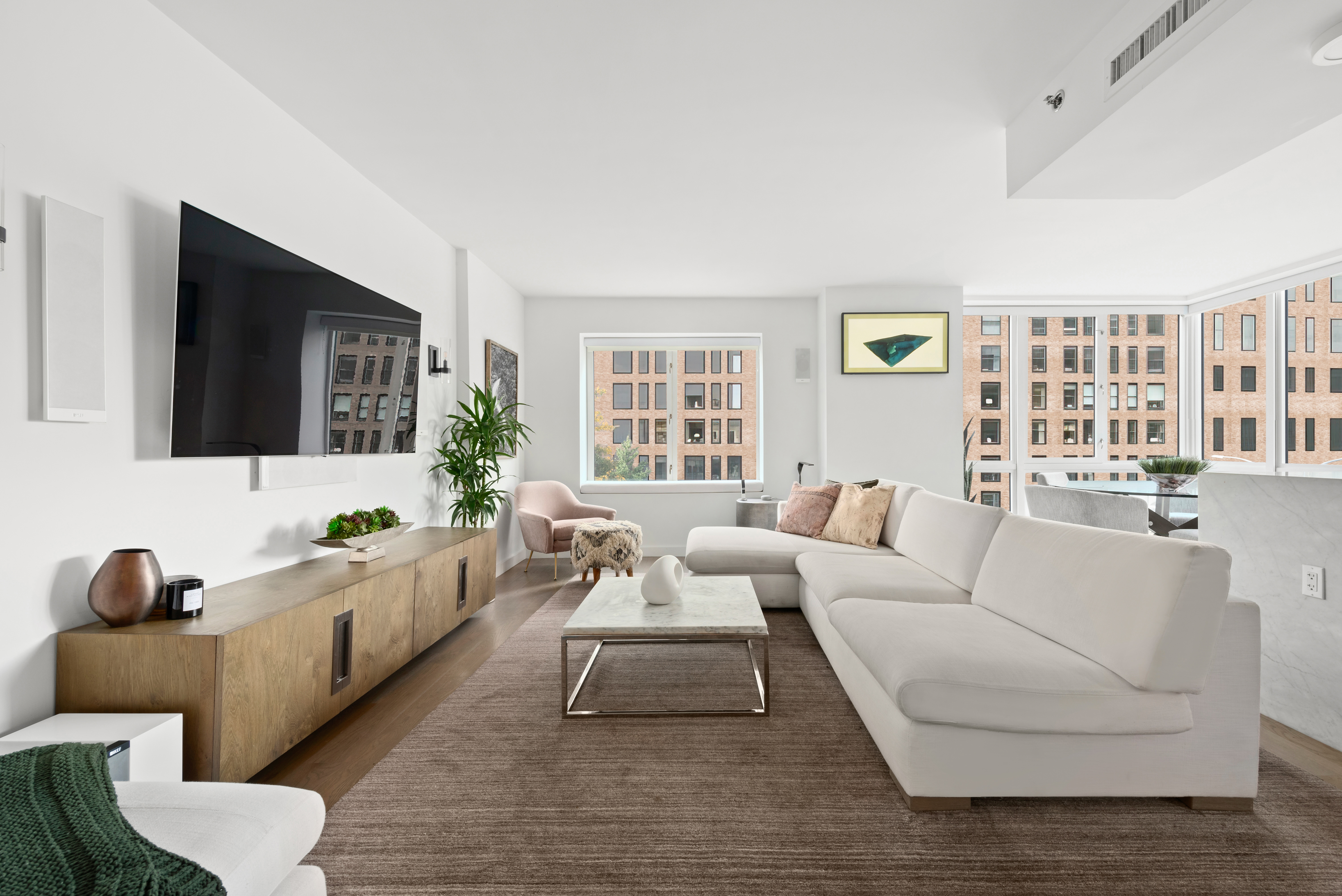 265 East Houston Street, Unit 4 Manhattan, NY 10002 - Photo 3 of 20 a living room with furniture and a flat screen tv