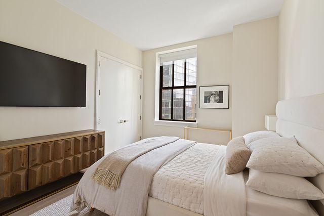 a bedroom with a bed and a window