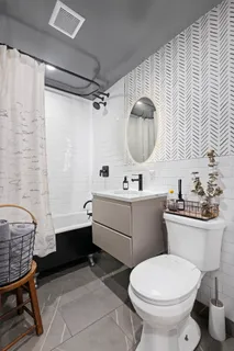 a bathroom with a sink toilet and a mirror