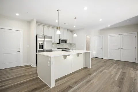 a kitchen with white cabinets and white appliances