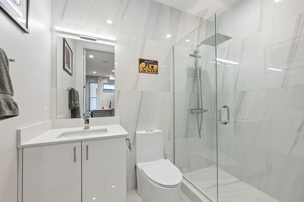 340 West 2nd Street, Unit 5 Boston, MA 02127 - Photo 15 of 26 a bathroom with a toilet a sink and shower