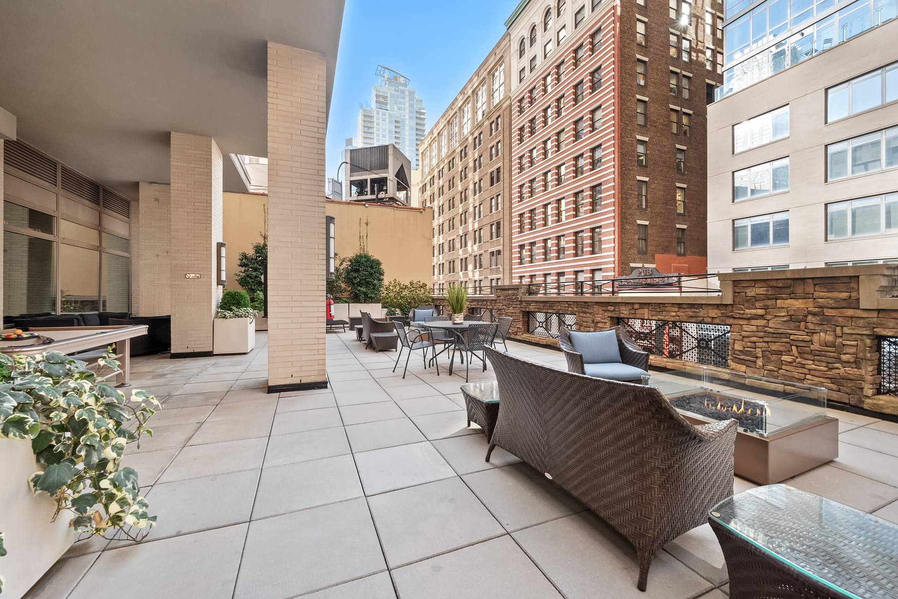 35 West 33rd Street, Unit 16F Manhattan, NY 10001 - Photo 17 of 34 a view of a patio with dining table and chairs