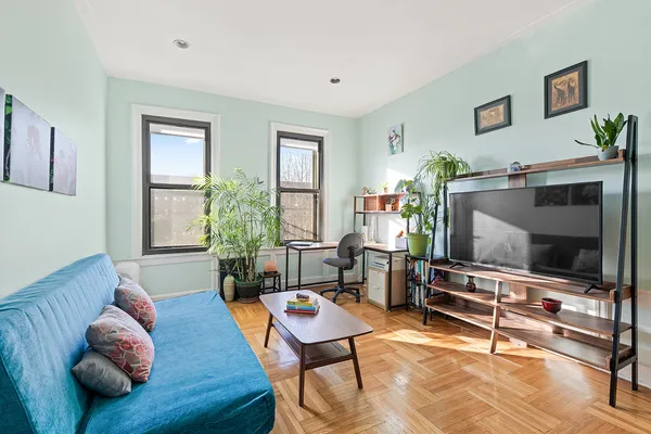 a living room with furniture and a flat screen tv