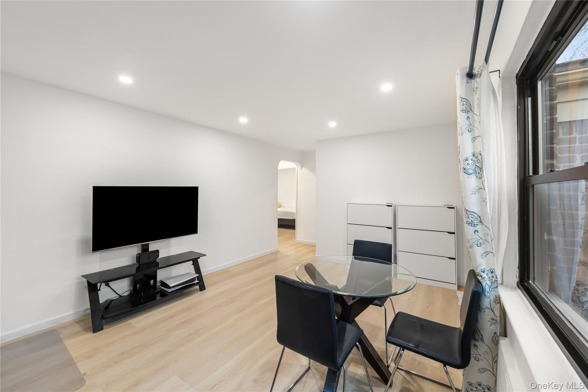 217-14 73rd Avenue, Unit 1 Queens, NY 11364 - Photo 6 of 19 a view of a livingroom with furniture and a flat screen tv