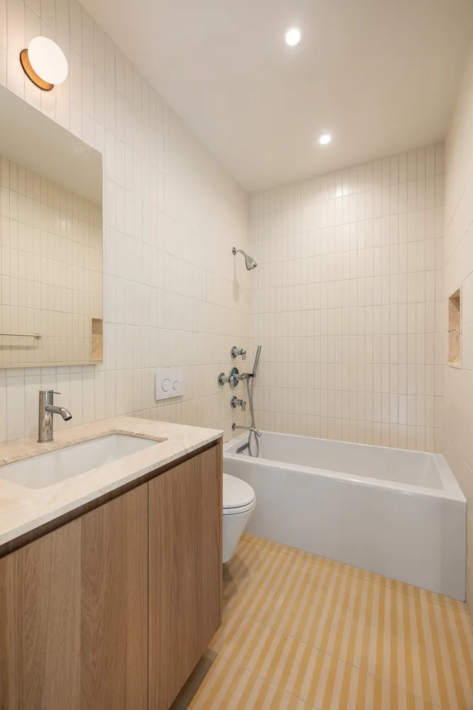 a bathroom with a granite countertop sink a toilet and bathtub