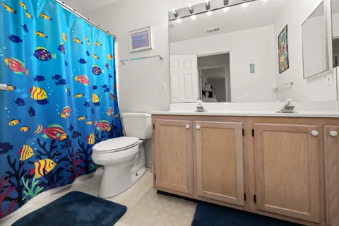 a bathroom with a sink a toilet and mirror
