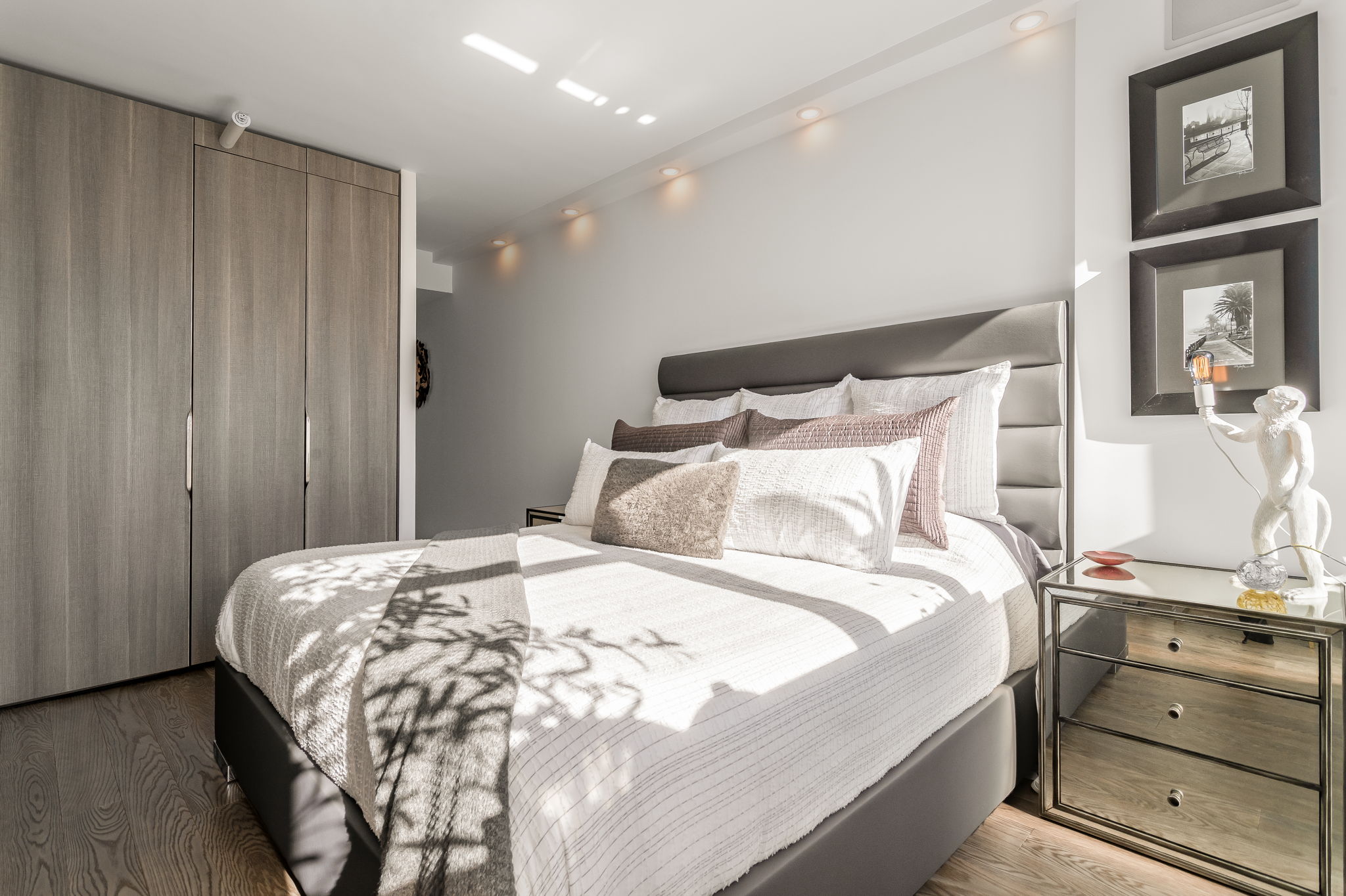 350 West 53rd Street, Unit PHB Manhattan, NY 10019 - Photo 13 of 34 a large bed sitting in a bedroom next to a cabinet