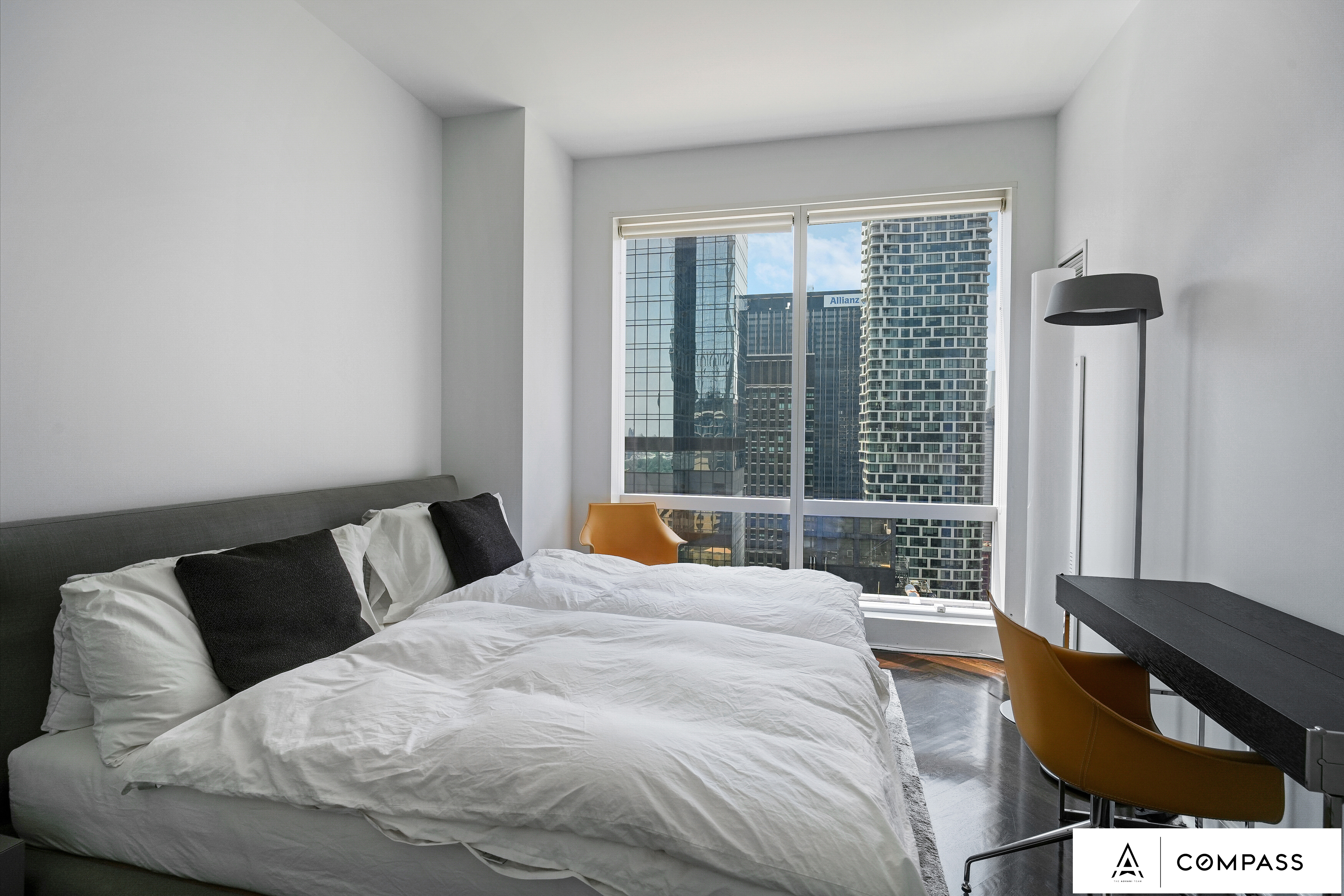 230 West 56th Street, Unit 49C Manhattan, NY 10019 - Photo 11 of 14 a bedroom with a bed and glass window