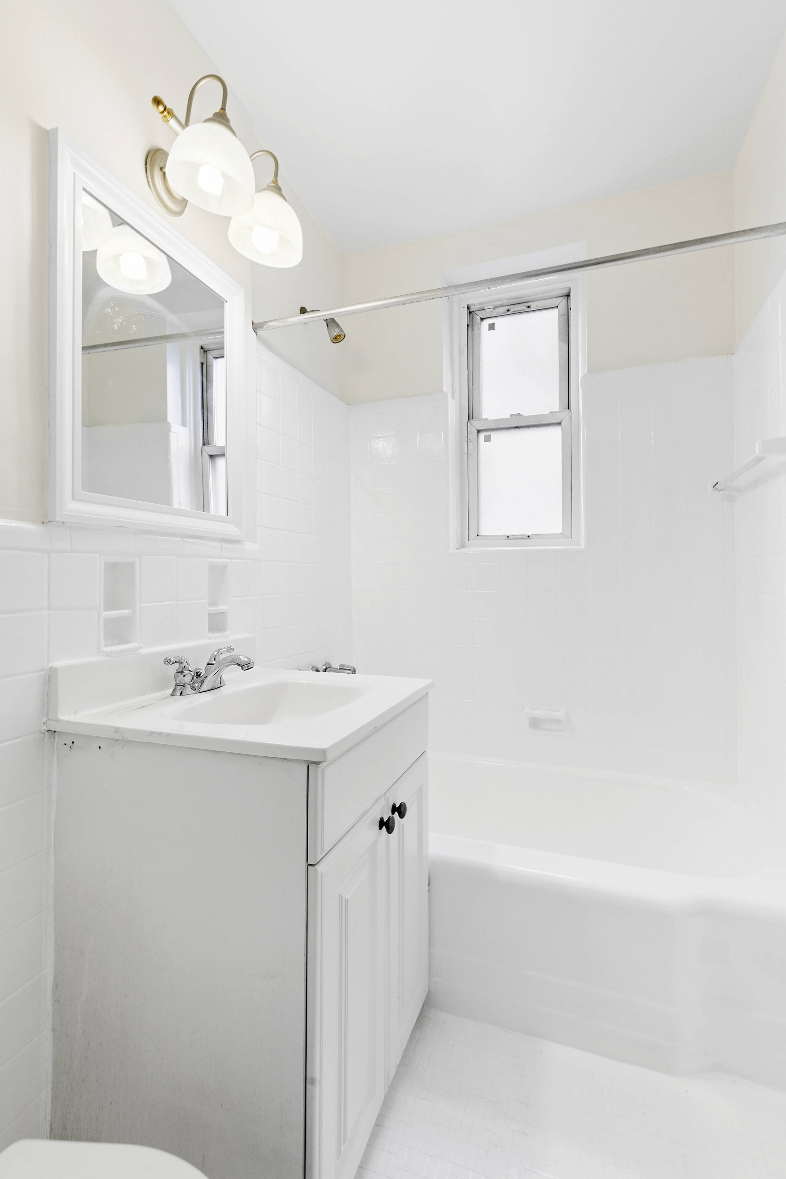 9801 Shore Road, Unit 1K Brooklyn, NY 11209 - Photo 8 of 11 a bathroom with a sink and a mirror