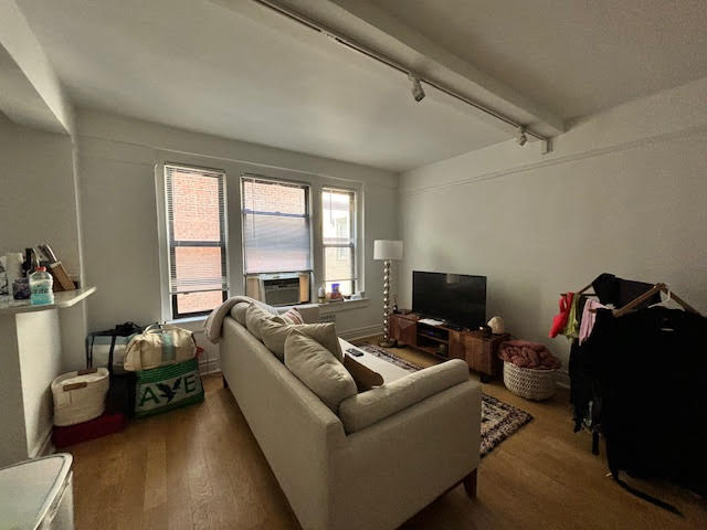 319 East 50th Street, Unit 10L Manhattan, NY 10022 - Photo 5 of 11 a living room with furniture and a flat screen tv