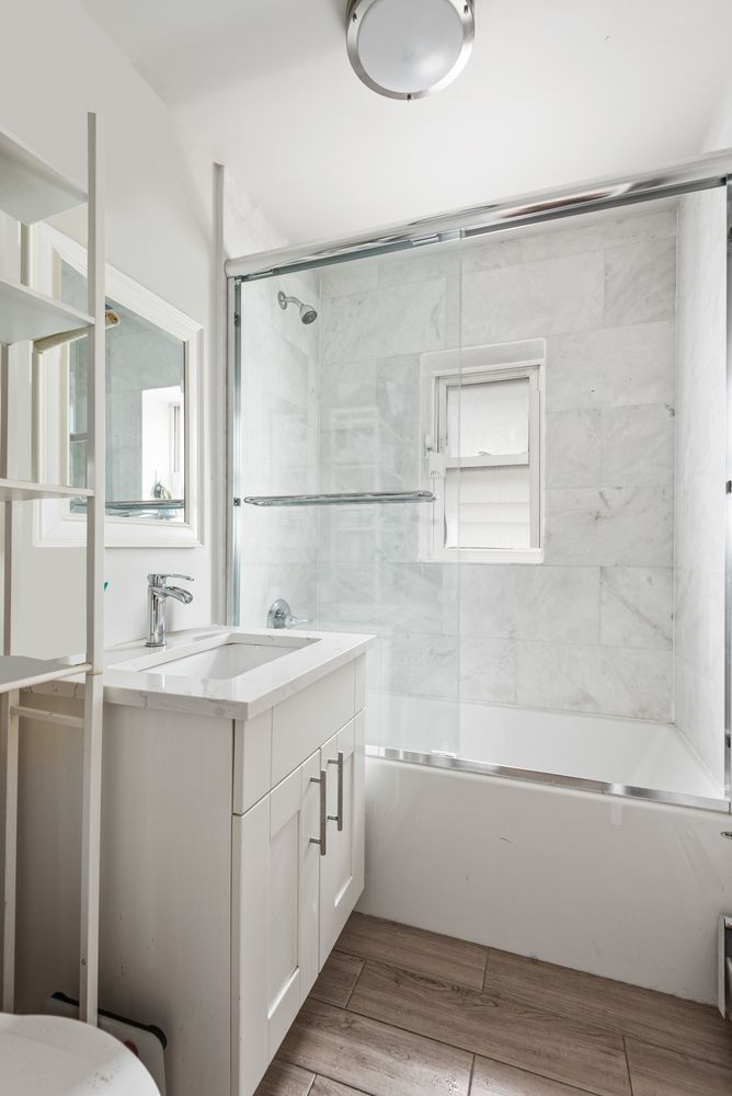 189 Woodpoint Road Brooklyn, NY 11211 - Photo 18 of 21 a bathroom with a sink and a mirror