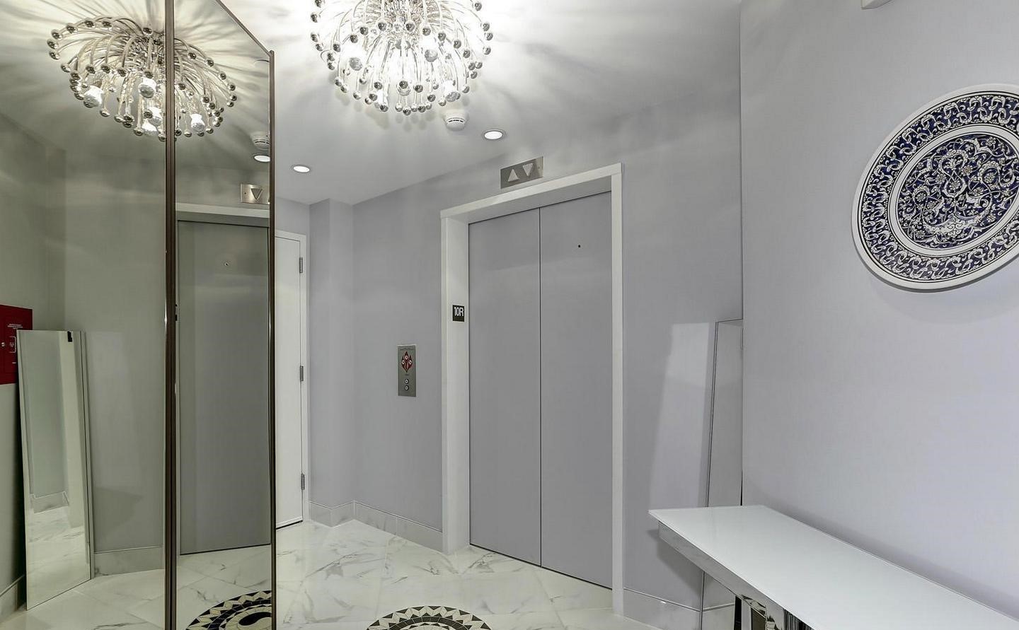 1881 North Nash Street, Unit 1009 Arlington, VA 22209 - Photo 14 of 36 a bathroom with a mirror and a shower