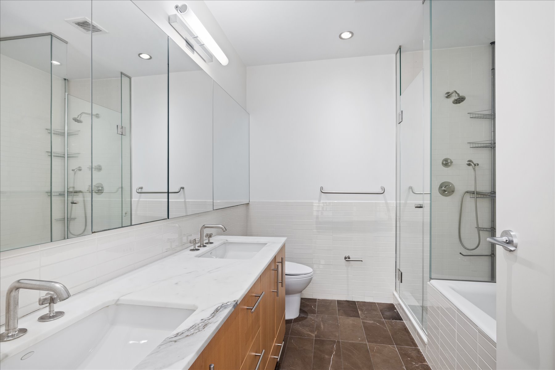 545 West 110th Street, Unit 2B Manhattan, NY 10025 - Photo 6 of 8 a bathroom with a tub sink shower and a mirror