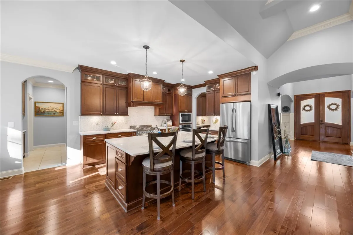 a kitchen with stainless steel appliances granite countertop a refrigerator and a sink