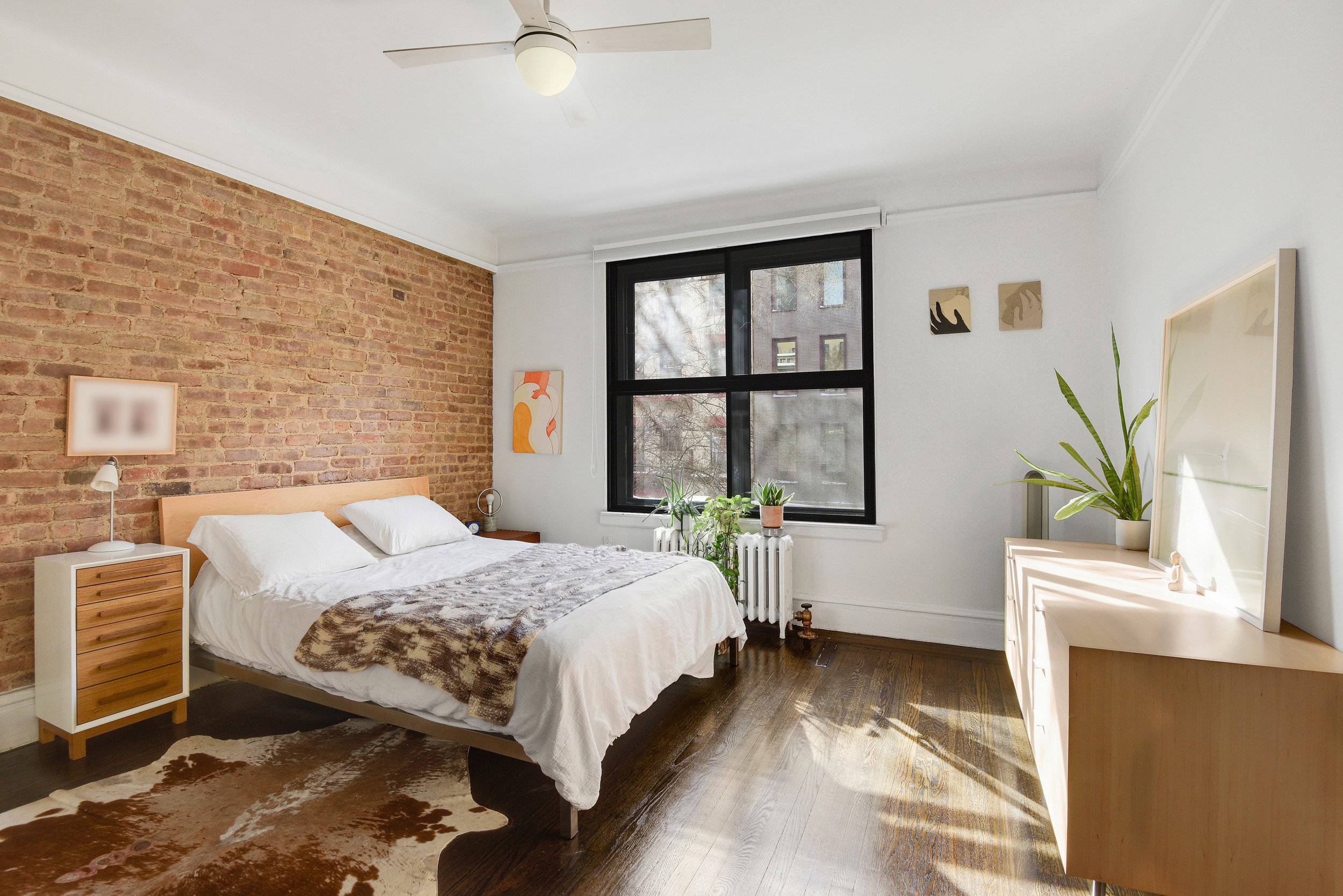 253 West 16th Street, Unit 3A Manhattan, NY 10011 - Photo 8 of 13 a bedroom with a bed and a window