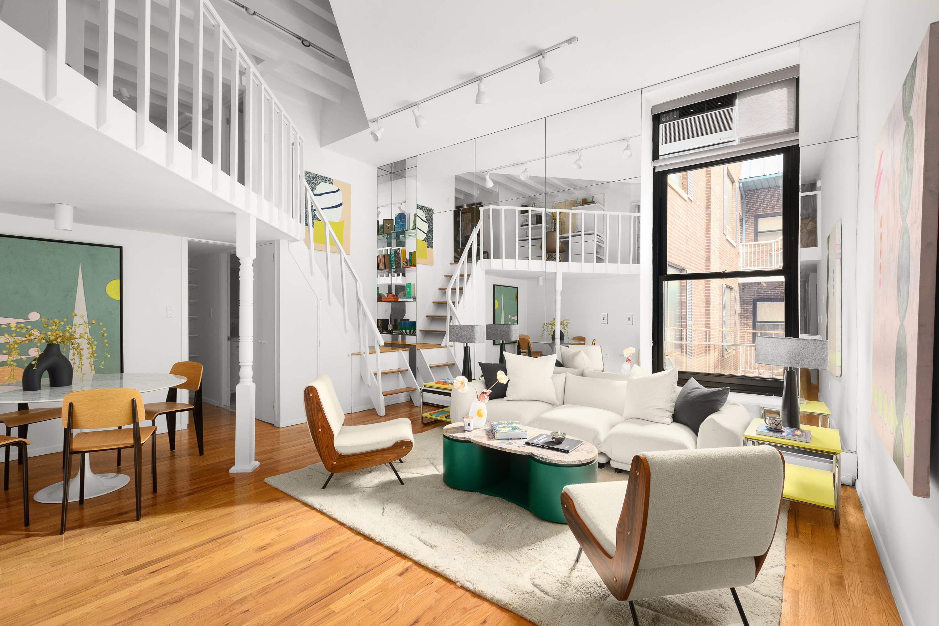 a living room with furniture fireplace and wooden floor