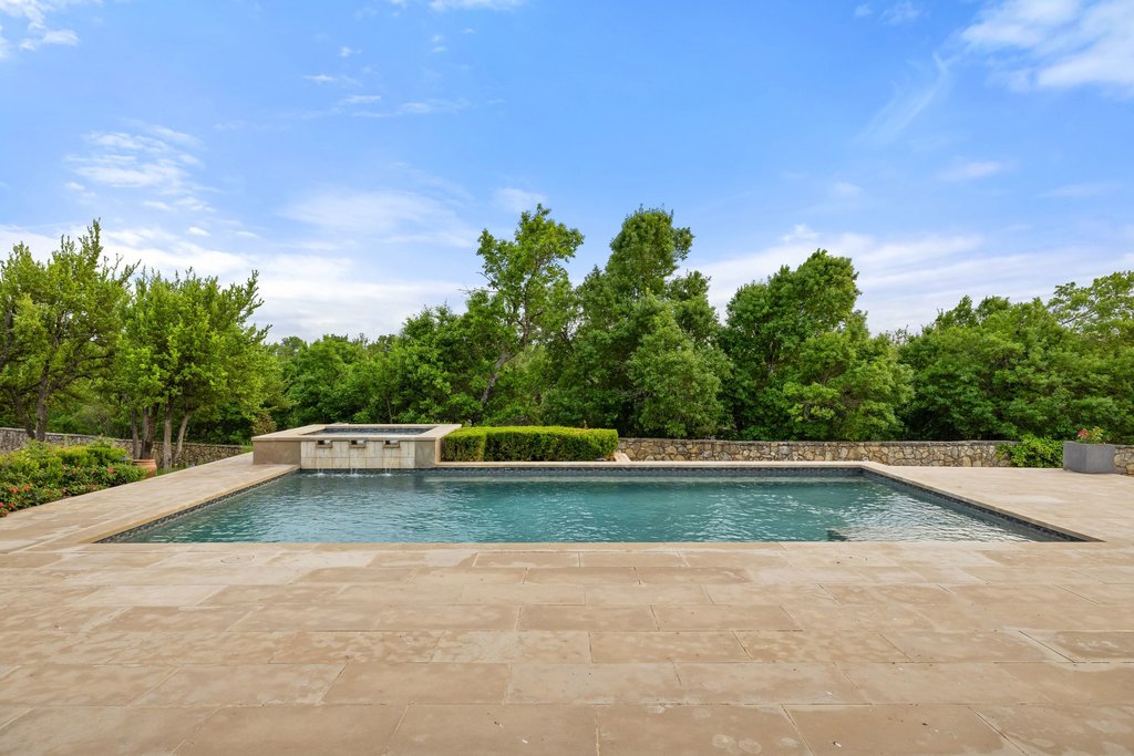 2560 Bell Springs Road Dripping Springs, TX 78620 - Photo 17 of 42 a view of a swimming pool and a yard