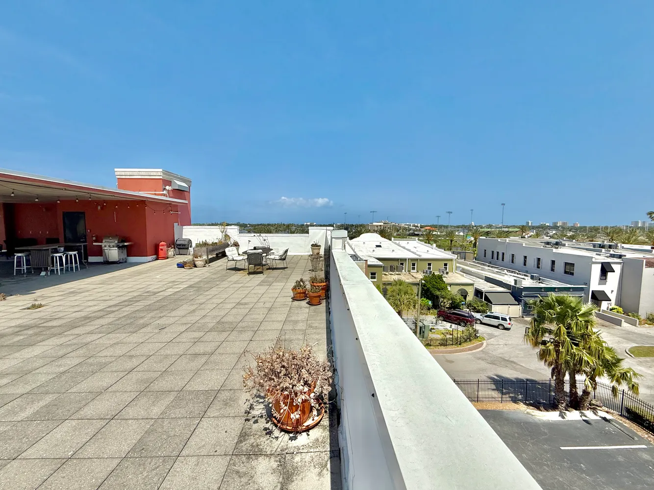 a view of a patio with dining table and chairs with a barbeque grill