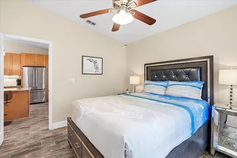 a bedroom with a bed and a chandelier