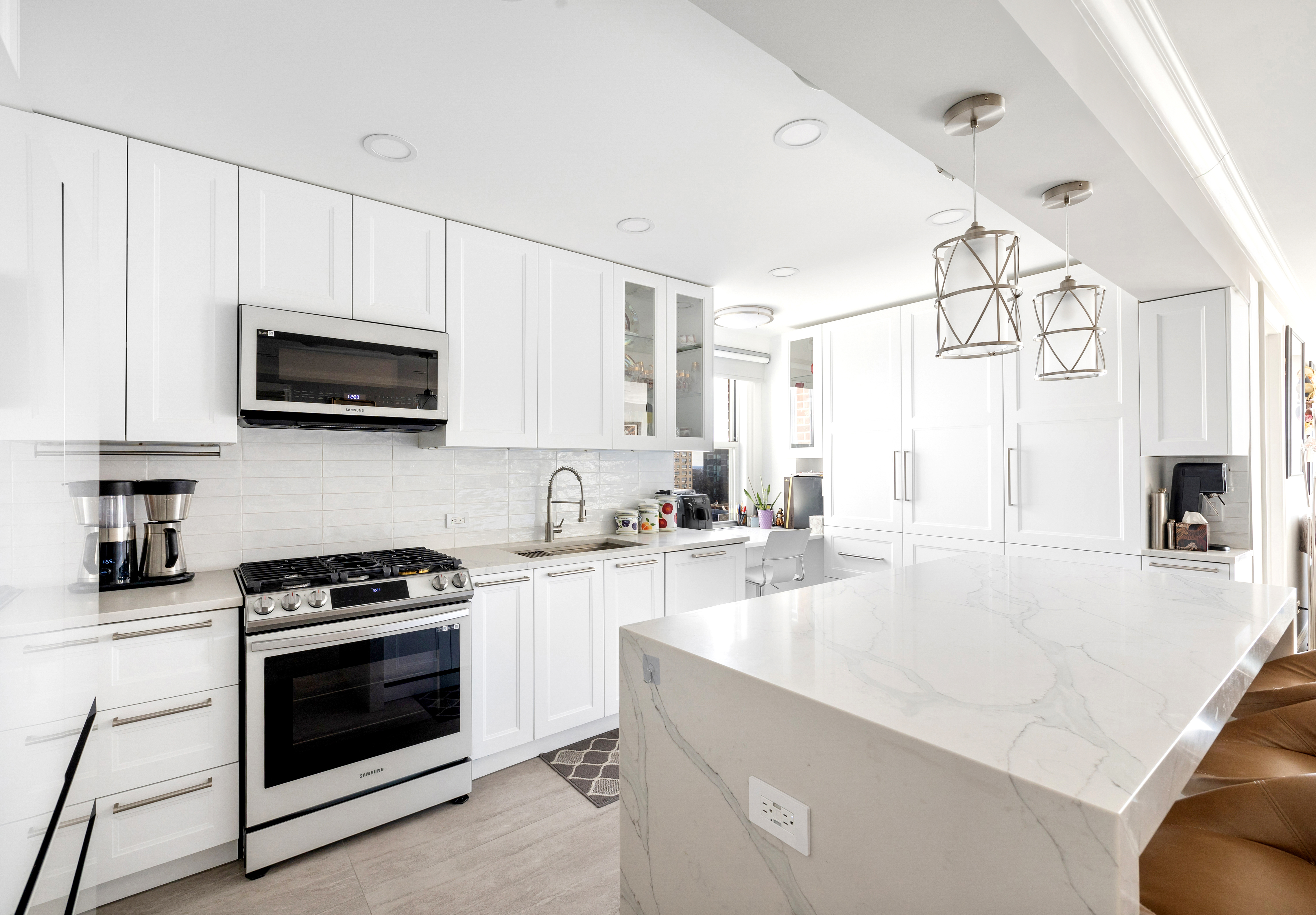 3755 Henry Hudson Parkway West, Unit PHA Bronx, NY 10463 - Photo 1 of 14 a kitchen with granite countertop a stove a sink and a microwave