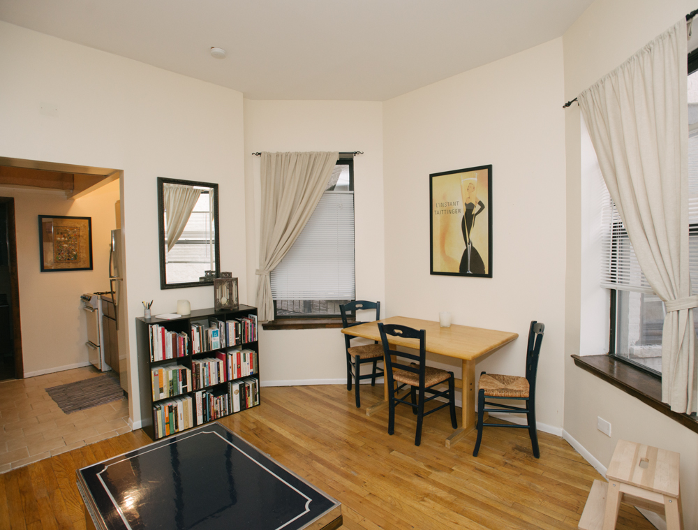 126 East 83rd Street, Unit 2C Manhattan, NY 10028 - Photo 3 of 5 a living room with furniture and a book shelf