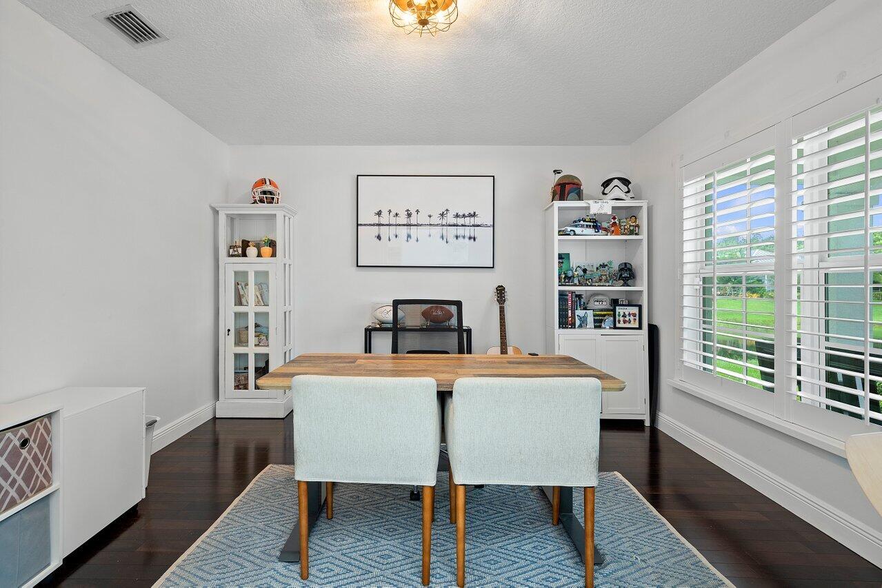 1182 Canoe Point Delray Beach, FL 33444 - Photo 18 of 46 a view of a dining room with furniture window and wooden floor
