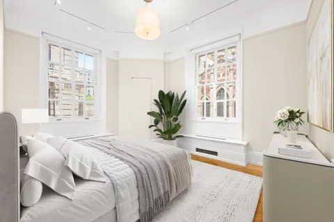 a bedroom with a large bed and a window