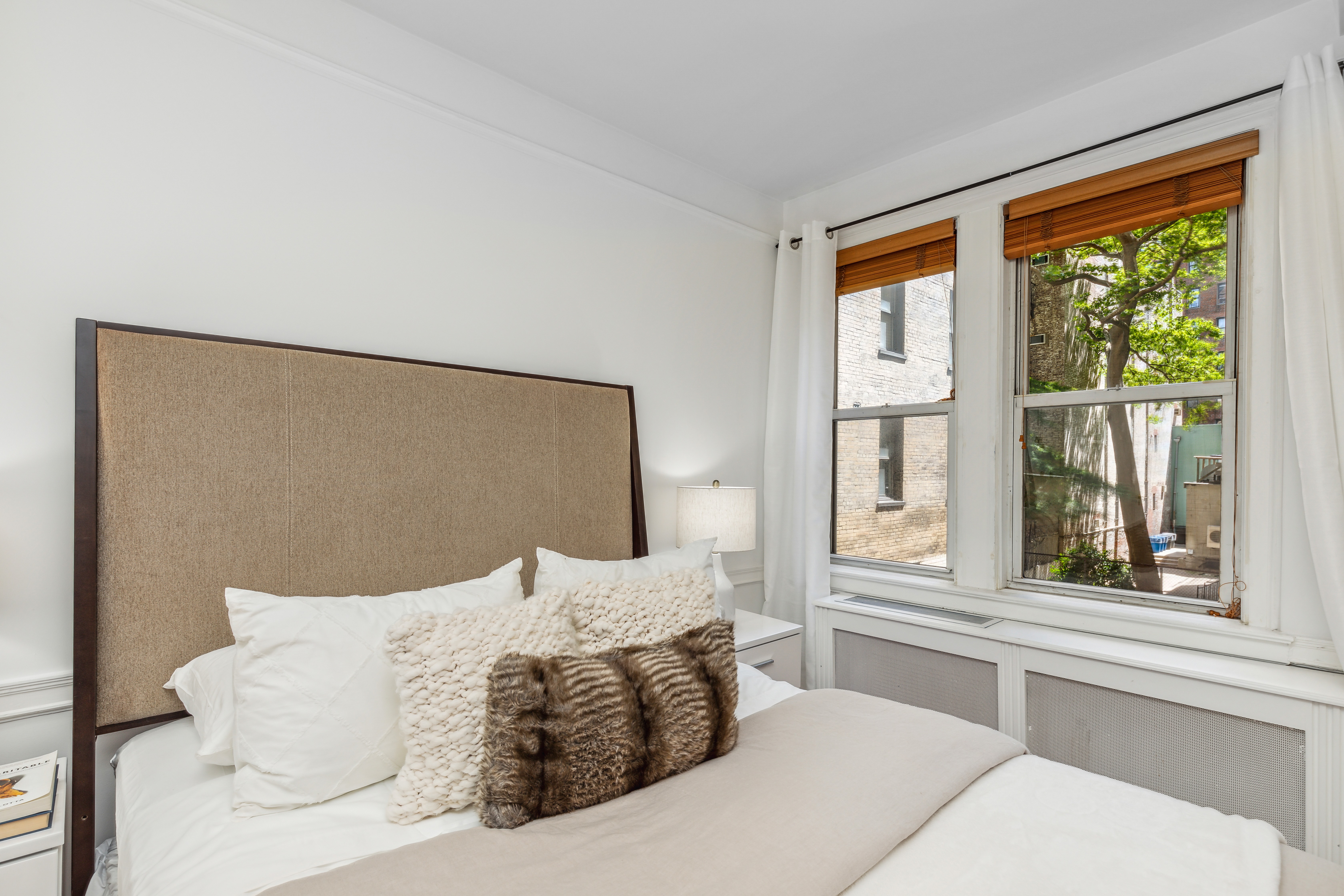 400 East 59th Street, Unit 2D Manhattan, NY 10022 - Photo 6 of 8 a bedroom with a large bed and a large window